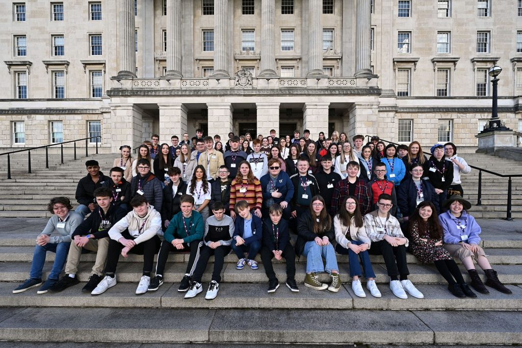 Members of the second mandate of the Northern Ireland Assembly's Youth Assembly on the front steps in front of the main entrance of Parliament Buildings, Stormont Estate.